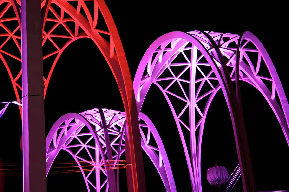 Purple and red lit arches above the Pacific Science Center in Seattle